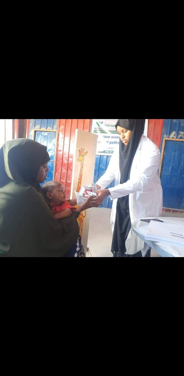 NASDO medical staff providing nutrition services to a mother and child