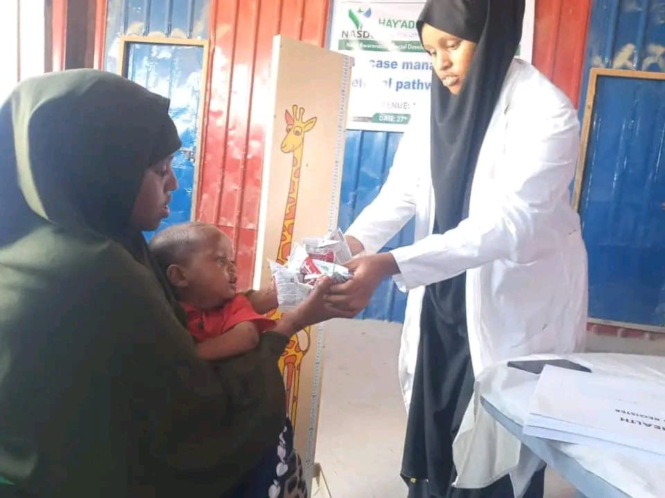 A child in Moyko Village receiving ready-to-use therapeutic food